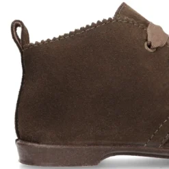 Botín tipo blucher con ondas y lazos en piel serraje.