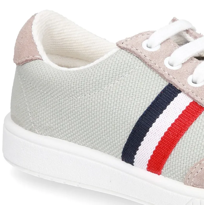 Tenis niño combinado en lona y serraje con cordones.
