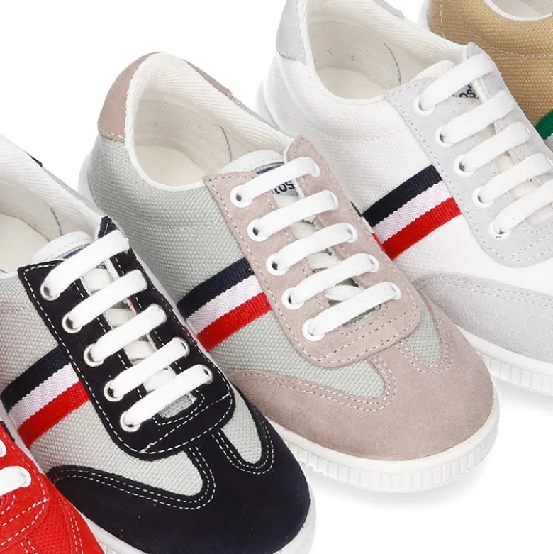Tenis niño combinado en lona y serraje con cordones.