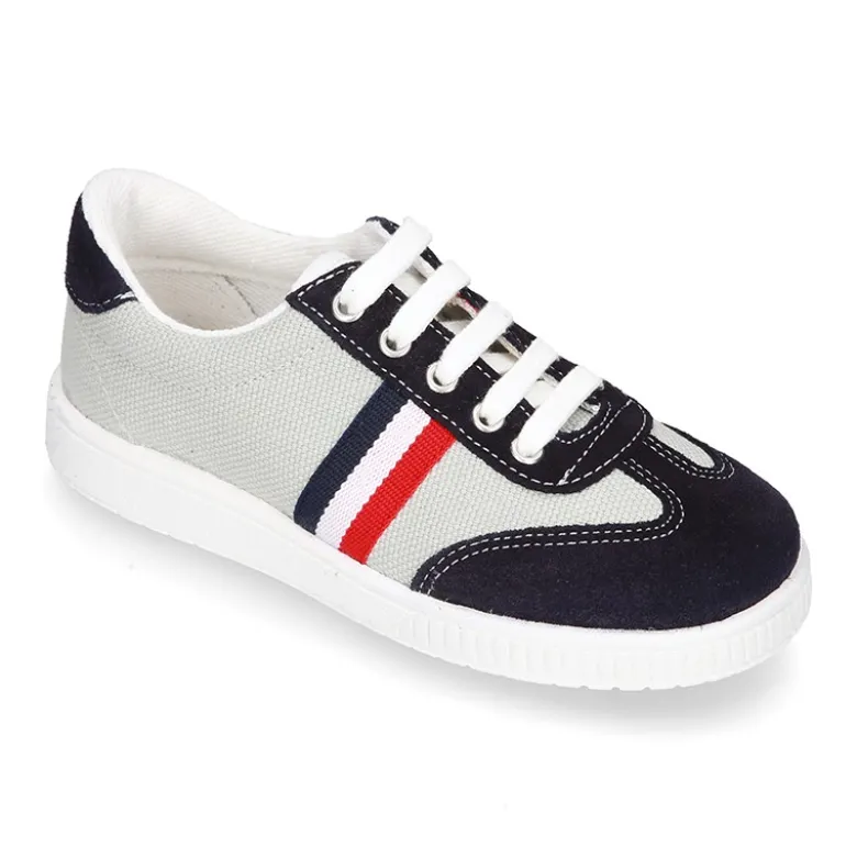 Tenis niño combinado en lona y serraje con cordones.