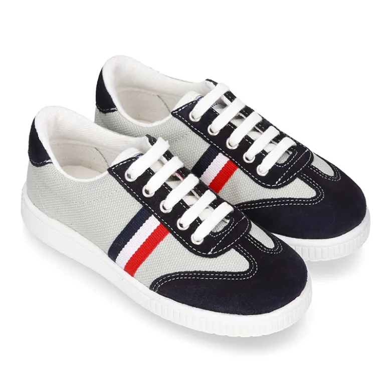 Tenis niño combinado en lona y serraje con cordones.