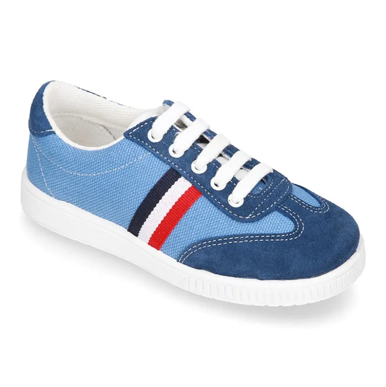 Tenis niño combinado en lona y serraje con cordones.