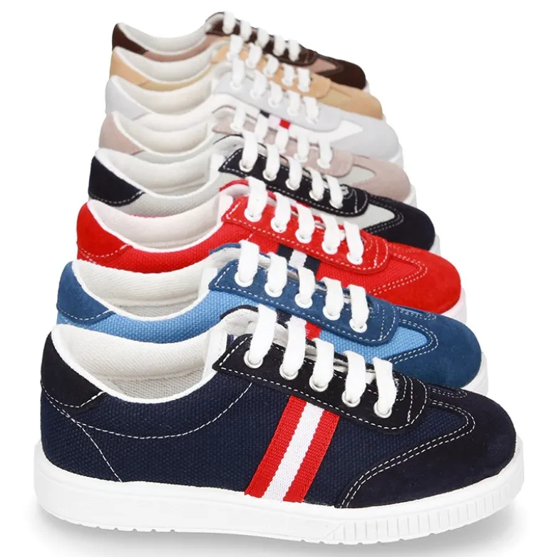 Tenis niño combinado en lona y serraje con cordones.