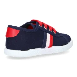 Tenis niño con cordones en lona con bandera.