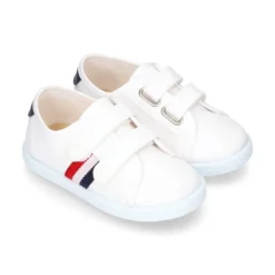 Tenis niño sin cordones en lona con bandera.