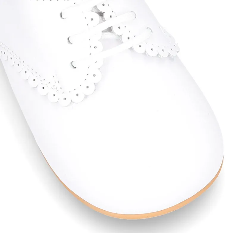 Zapatito clásico tipo BLUCHER con festón en piel napa.